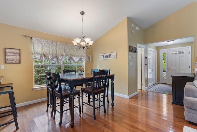 1313 Deer Run, Casco, ME 04015 - dining area with a chandelier, wood finished floors, and high vaulted ceiling