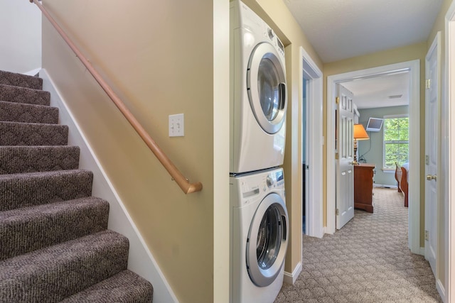 1313 Deer Run, Casco, ME 04015 - laundry area with stacked washing machine and dryer and light colored carpet