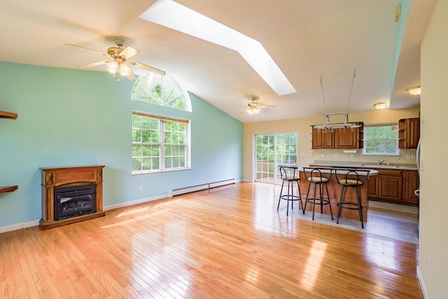 421 Cushing Rd, Cushing, ME 04563 - kitchen featuring baseboard heating, a skylight, a ceiling fan, lofted ceiling, and a kitchen breakfast bar
