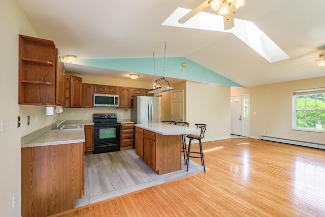 421 Cushing Rd, Cushing, ME 04563 - kitchen featuring stainless steel appliances, a ceiling fan, light wood-style flooring, vaulted ceiling, and open shelves