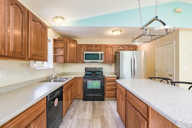 421 Cushing Rd, Cushing, ME 04563 - kitchen featuring black appliances, brown cabinetry, light countertops, and light wood-type flooring