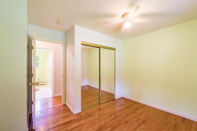 421 Cushing Rd, Cushing, ME 04563 - unfurnished bedroom featuring wood finished floors, a closet, and a ceiling fan