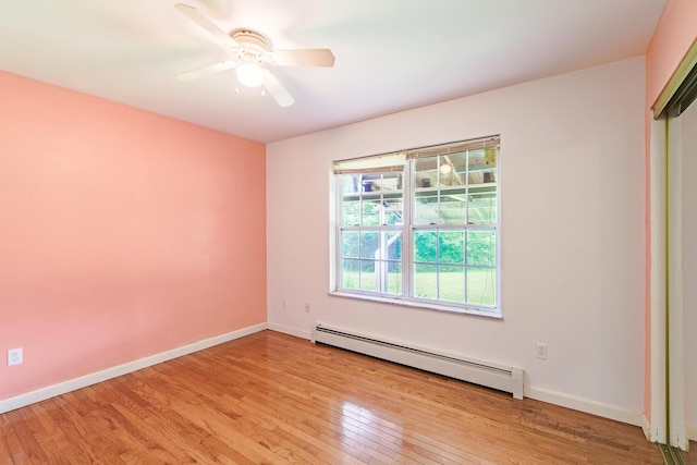 421 Cushing Rd, Cushing, ME 04563 - spare room with a baseboard radiator, light wood finished floors, and a ceiling fan