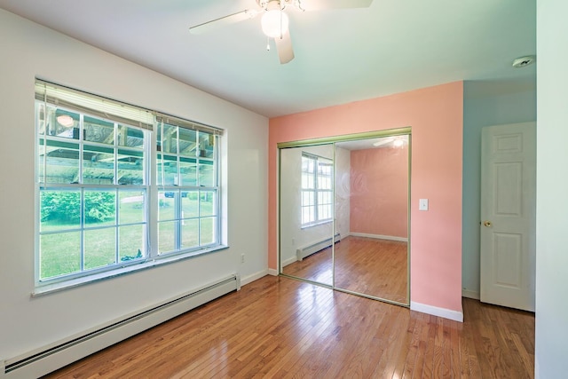 421 Cushing Rd, Cushing, ME 04563 - unfurnished bedroom featuring baseboard heating, light wood-style flooring, a closet, and ceiling fan