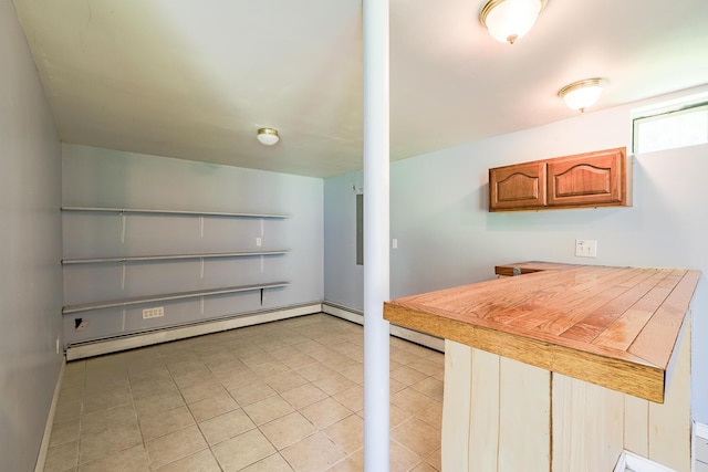 421 Cushing Rd, Cushing, ME 04563 - kitchen with a baseboard radiator, light tile patterned floors, brown cabinets, and light countertops