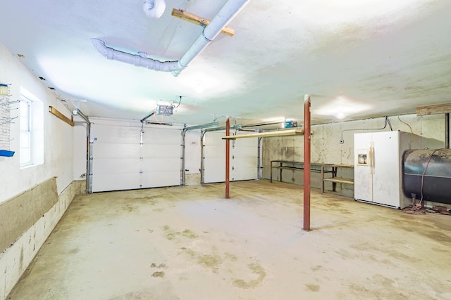 421 Cushing Rd, Cushing, ME 04563 - garage featuring oil tank and a garage door opener