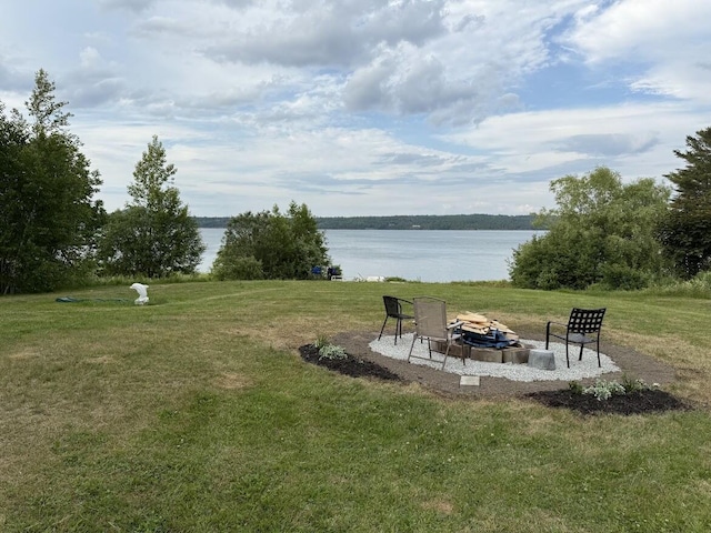 631 US Rt 1, Robbinston, ME 04671 - view of grassy yard featuring an outdoor fire pit and a water view