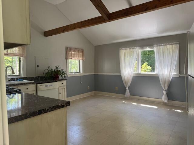27 Dodge Rd, Edgecomb, ME 04556 - kitchen with white dishwasher, beam ceiling, dark stone countertops, and high vaulted ceiling