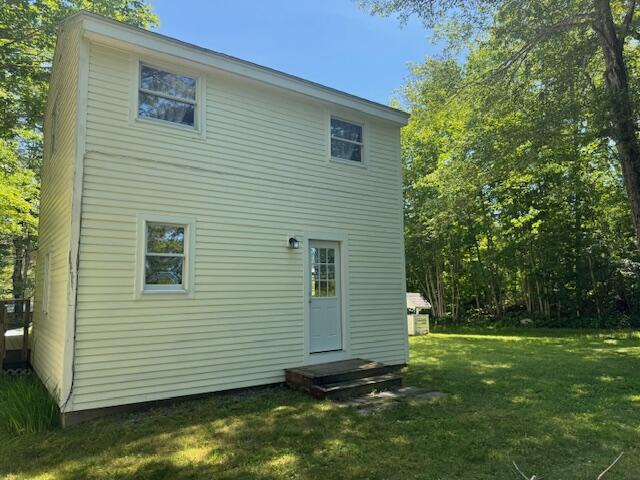 27 Dodge Rd, Edgecomb, ME 04556 - back of house featuring a lawn