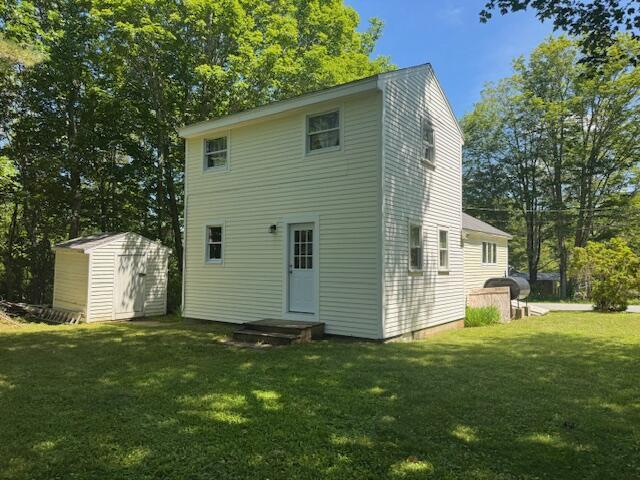 27 Dodge Rd, Edgecomb, ME 04556 - back of property with a storage shed, a lawn, and view of scattered trees