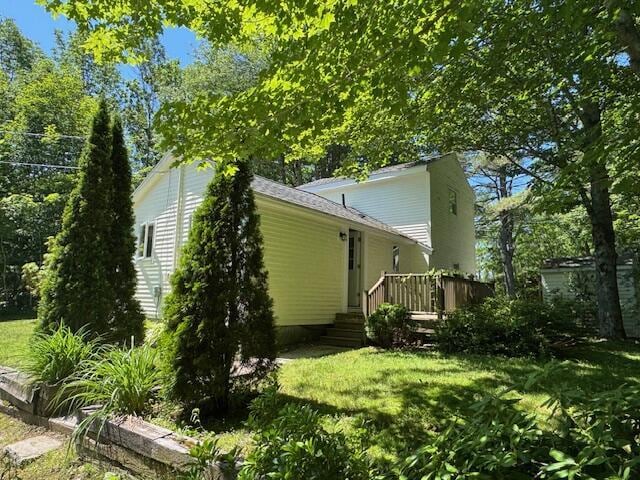 27 Dodge Rd, Edgecomb, ME 04556 - back of property with a wooden deck and a lawn