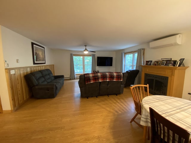 48 Stoney Ridge Rd, Eddington, ME 04428 - living room with a wall mounted AC, light wood-style flooring, plenty of natural light, and a fireplace