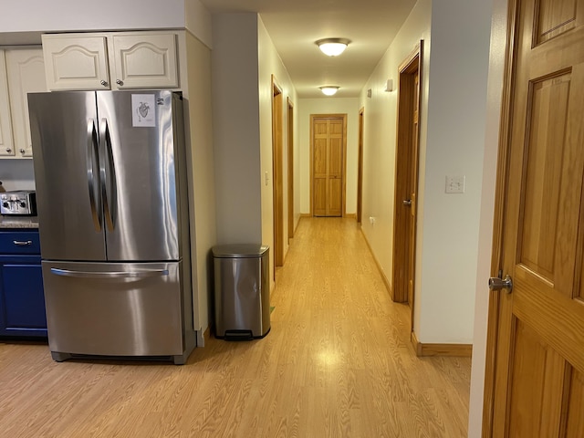 48 Stoney Ridge Rd, Eddington, ME 04428 - kitchen featuring freestanding refrigerator, light wood-type flooring, blue cabinetry, and white cabinetry