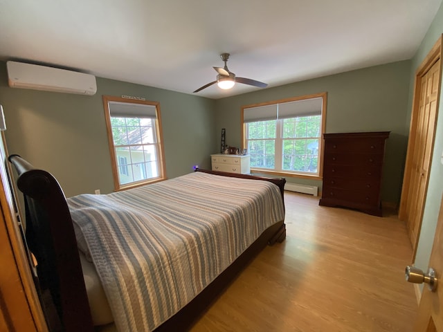 48 Stoney Ridge Rd, Eddington, ME 04428 - bedroom featuring a wall mounted AC, multiple windows, wood finished floors, and ceiling fan