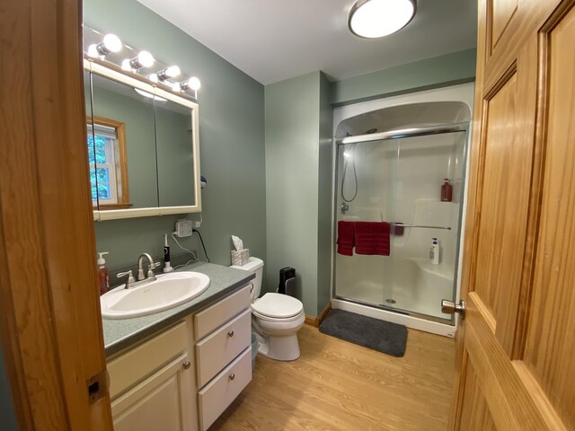48 Stoney Ridge Rd, Eddington, ME 04428 - bathroom with a stall shower, vanity, and wood finished floors