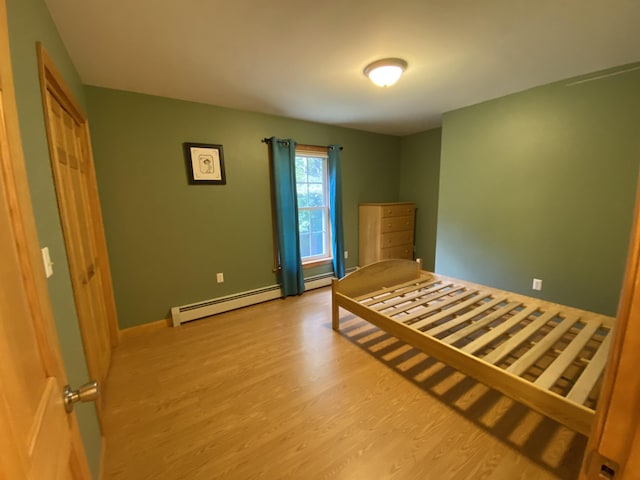 48 Stoney Ridge Rd, Eddington, ME 04428 - unfurnished bedroom with baseboard heating and wood finished floors