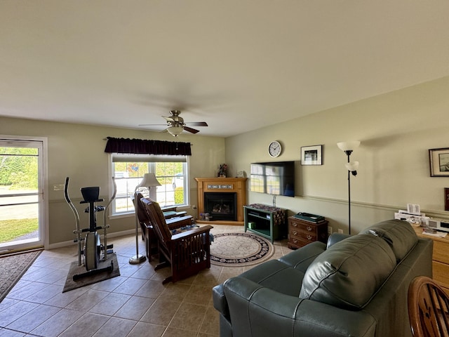 35A Birchbrook Ln Unit 35A, Levant, ME 04456 - living room with dark tile patterned flooring, a ceiling fan, and a fireplace with raised hearth