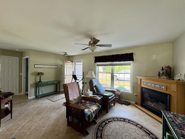 35A Birchbrook Ln Unit 35A, Levant, ME 04456 - living room with light tile patterned flooring, a glass covered fireplace, and ceiling fan