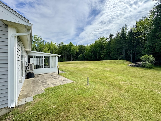 35A Birchbrook Ln Unit 35A, Levant, ME 04456 - view of green lawn featuring a patio, a sunroom, and a view of trees