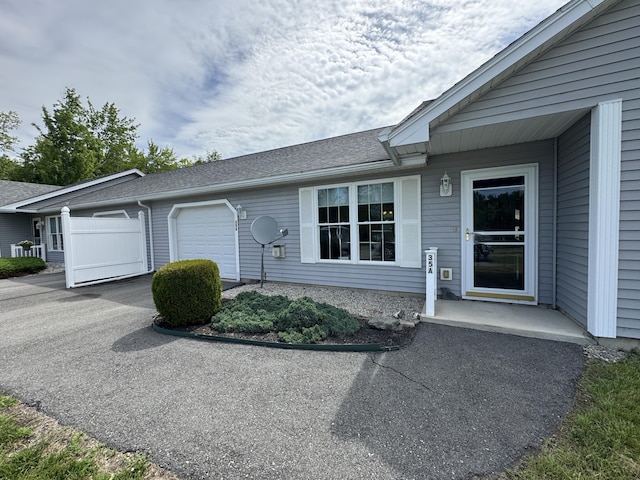 35A Birchbrook Ln Unit 35A, Levant, ME 04456 - view of front of house with an attached garage, driveway, and roof with shingles