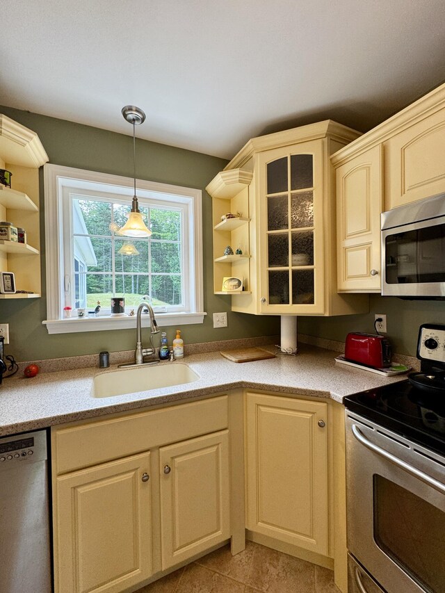 35A Birchbrook Ln Unit 35A, Levant, ME 04456 - kitchen featuring appliances with stainless steel finishes, open shelves, light countertops, and decorative light fixtures