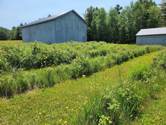 183 Folsom Pond Rd, Lincoln, ME 04457 - view of yard featuring a pole building and an outbuilding