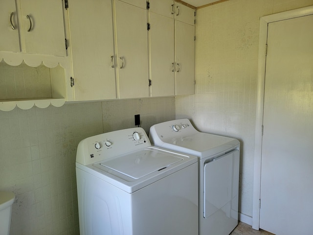 183 Folsom Pond Rd, Lincoln, ME 04457 - laundry room with washing machine and clothes dryer, tile walls, and cabinet space