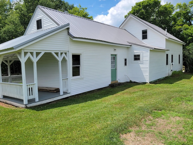 183 Folsom Pond Rd, Lincoln, ME 04457 - back of house featuring a lawn, a porch, and a metal roof