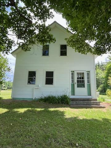 183 Folsom Pond Rd, Lincoln, ME 04457 - rear view of house with entry steps and a yard