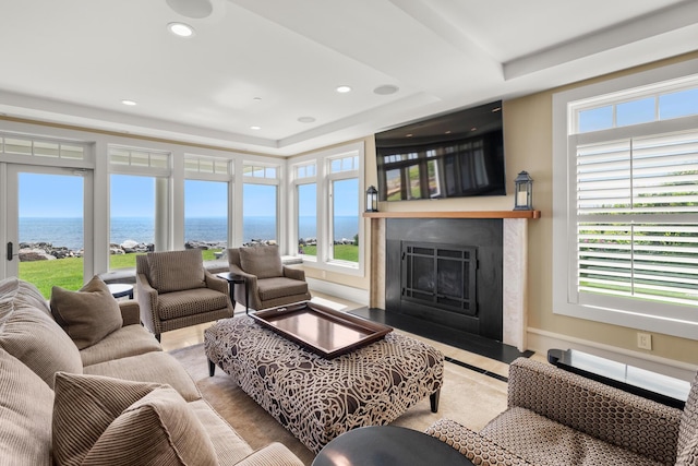121 Bald Head Cliff Rd, York, ME 03902 - living room featuring a water view, a fireplace with flush hearth, recessed lighting, and a raised ceiling