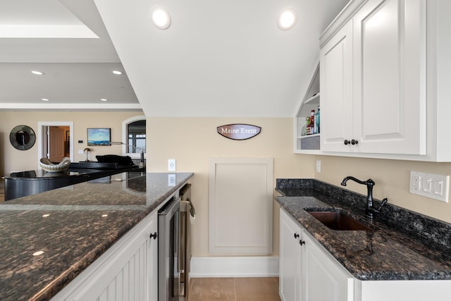 121 Bald Head Cliff Rd, York, ME 03902 - kitchen featuring beverage cooler, white cabinetry, dark stone countertops, recessed lighting, and arched walkways