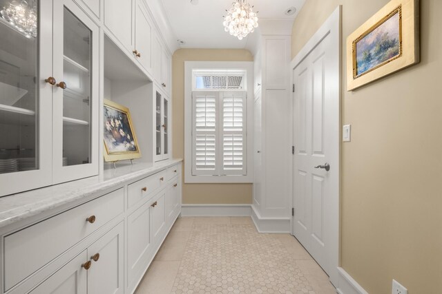 121 Bald Head Cliff Rd, York, ME 03902 - hallway with a chandelier and light tile patterned floors