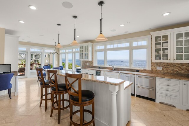 121 Bald Head Cliff Rd, York, ME 03902 - kitchen with dishwasher, backsplash, plenty of natural light, a water view, and recessed lighting