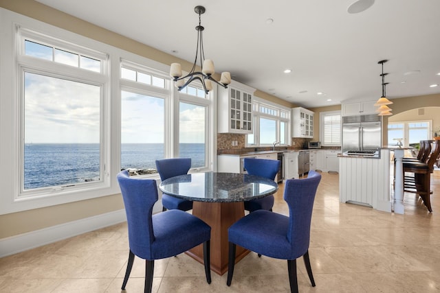121 Bald Head Cliff Rd, York, ME 03902 - dining room featuring light tile patterned floors, recessed lighting, and a water view