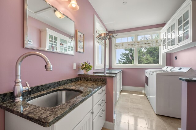 121 Bald Head Cliff Rd, York, ME 03902 - laundry room featuring cabinet space, separate washer and dryer, and light tile patterned floors