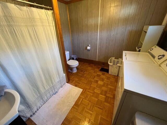 6 Chicken St, Starks, ME 04911 - full bathroom with wooden walls, a shower with curtain, vanity, and washing machine and dryer