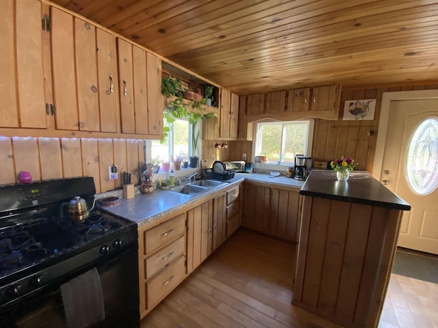 6 Chicken St, Starks, ME 04911 - kitchen featuring black range with gas stovetop, wooden ceiling, wooden walls, light wood finished floors, and light brown cabinetry