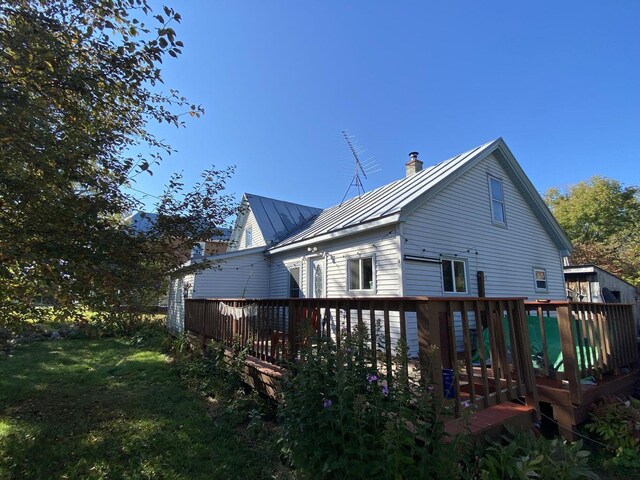 6 Chicken St, Starks, ME 04911 - rear view of house featuring a standing seam roof, a wooden deck, a metal roof, and a chimney