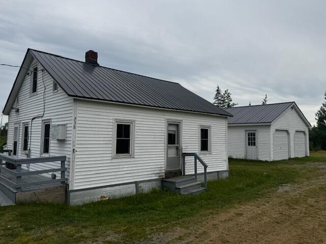 238 Shadagee Rd, Cornville, ME 04976 - rear view of property with a chimney and a metal roof