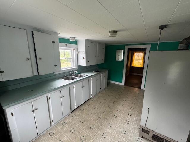 238 Shadagee Rd, Cornville, ME 04976 - kitchen with freestanding refrigerator, white cabinetry, light flooring, and light countertops