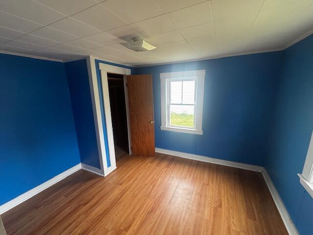 238 Shadagee Rd, Cornville, ME 04976 - unfurnished bedroom with wood finished floors and crown molding