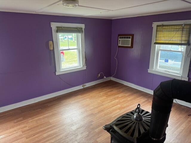 238 Shadagee Rd, Cornville, ME 04976 - spare room with an AC wall unit, light wood finished floors, and crown molding