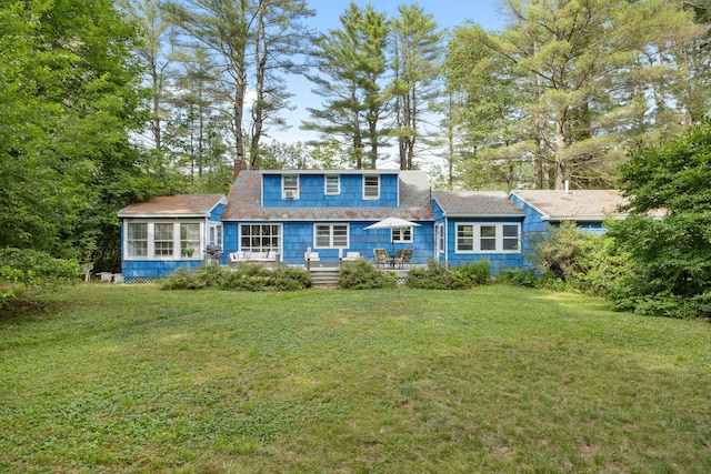 97 Forest Ave, Orono, ME 04473 - rear view of house featuring a chimney, a sunroom, a yard, and a wooden deck