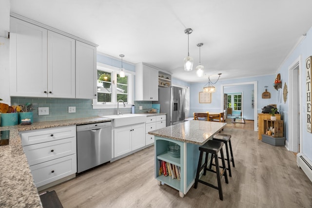97 Forest Ave, Orono, ME 04473 - kitchen featuring appliances with stainless steel finishes, open shelves, tasteful backsplash, light wood-style floors, and ornamental molding