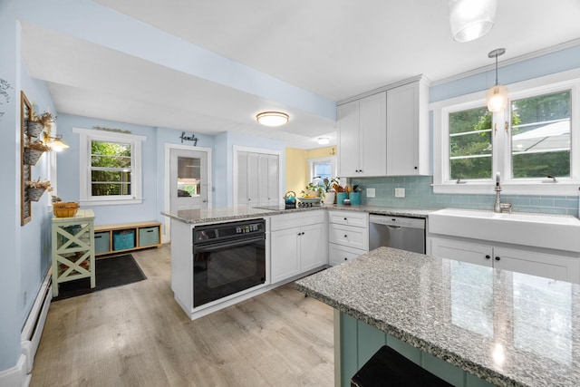 97 Forest Ave, Orono, ME 04473 - kitchen featuring oven, dishwasher, a peninsula, and light wood finished floors