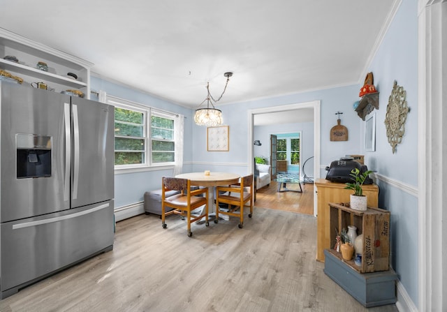 97 Forest Ave, Orono, ME 04473 - dining area with plenty of natural light, light wood finished floors, baseboard heating, ornamental molding, and a chandelier