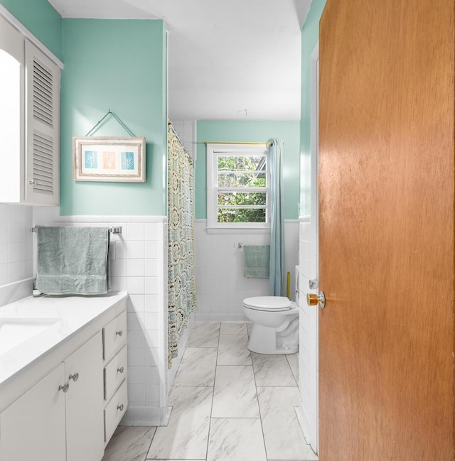 97 Forest Ave, Orono, ME 04473 - bathroom with tile walls, marble finish floors, vanity, a wainscoted wall, and curtained shower
