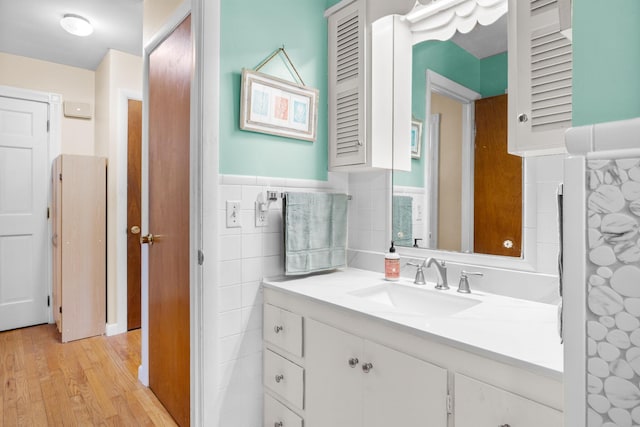 97 Forest Ave, Orono, ME 04473 - bathroom with vanity, wood finished floors, wainscoting, and tile walls