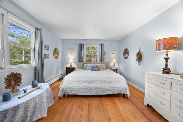 97 Forest Ave, Orono, ME 04473 - bedroom featuring baseboard heating and light wood-style floors