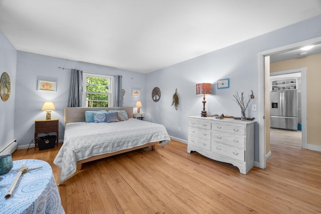 97 Forest Ave, Orono, ME 04473 - bedroom with stainless steel refrigerator with ice dispenser, light wood-style floors, and a baseboard heating unit